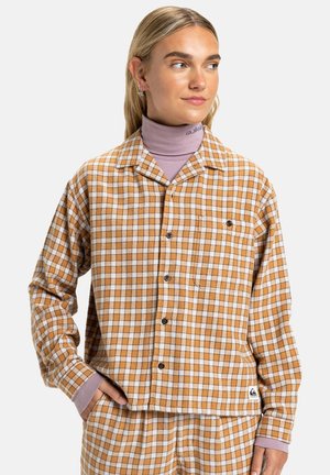 Brown and white checkered button-up shirt made of soft fabric, featuring a chest pocket and contrasting purple cuffs.