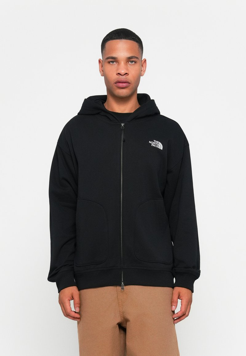 Black zip-up hoodie made of smooth fabric, featuring a front zipper, two side pockets, and a logo on the upper left chest area.