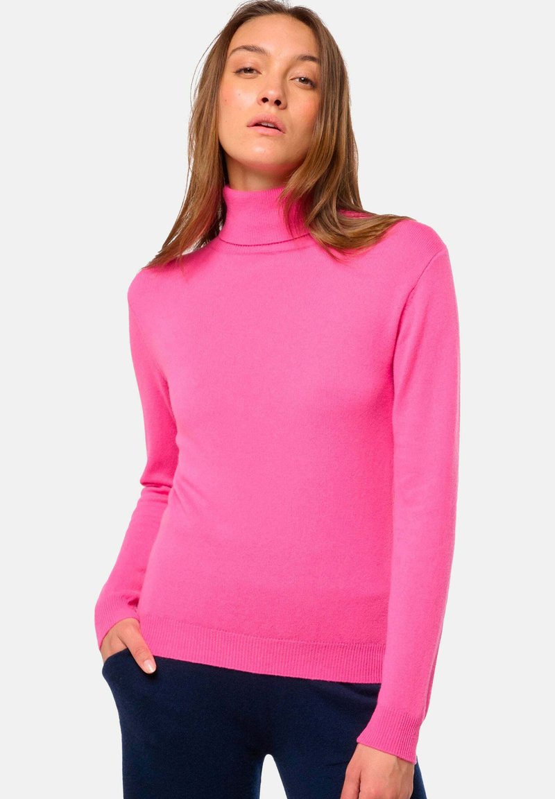 Rosa Rollkragenpullover aus weichem Material, mit langen Ärmeln und taillierter Passform. Rippbündchen und Saum sorgen für eine dezente Textur.