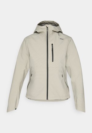 Hellebeige Kapuzenjacke mit frontalem Reißverschluss, Reißverschlusstasche auf der Brust und zwei seitlichen Reißverschlusstaschen, entworfen für den Outdoor-Einsatz.