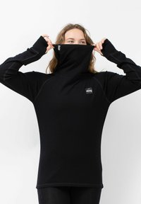 Schwarzes langärmliges Oberteil mit hohem Kragen, versehen mit einem Logo-Patch und Daumenlöchern. Hergestellt aus einem glatten, dehnbaren Stoff mit Nahtdetails.