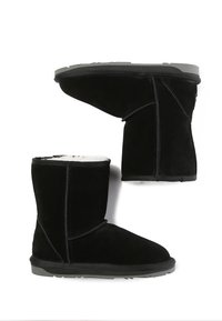 Black suede ankle boots with a soft interior lining, flat rubber sole, and contrasting stitching detail on the sides.