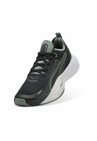 Chaussure de course noire et vert clair avec une tige en maille respirante, une surface texturée, un col rembourré et une épaisse semelle blanche.