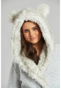 Accappatoio con cappuccio grigio chiaro, realizzato in materiale morbido e peloso. Presenta orecchie da orso sul cappuccio e una superficie testurizzata.