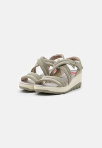 Open-toe wedge sandals with crisscross elastic straps in muted green. Cushioned insole and sturdy, contoured outsole for comfort.