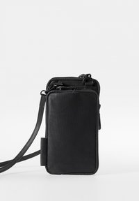 Black leather crossbody bag with a smooth texture, rectangular shape, zippered compartments, and an adjustable strap for convenience.