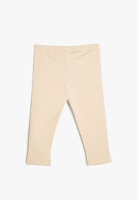 Leggings de algodón beige con un ajuste slim, cintura elástica y sin costuras visibles. Textura suave y diseño de largo hasta el tobillo.