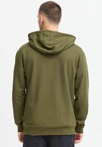 Olive green hooded sweatshirt with a relaxed fit, ribbed cuffs and hem, soft fabric texture, and visible stitching details.