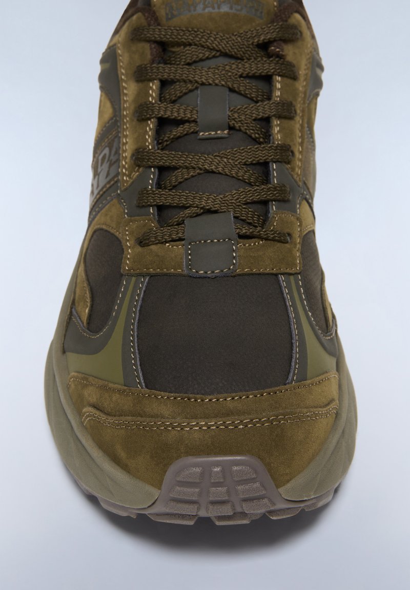 Olivgrüne Sneakers aus Wildleder und Mesh-Materialien mit runder Zehenpartie, gepolsterter Zunge, dicken Schnürsenkeln und strukturiertem Gummiuntergrund.