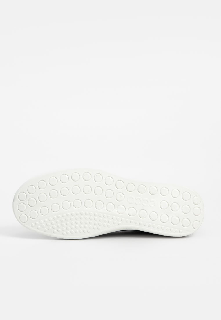 Schuhsohle mit einer weißen Gummibasis, die ein gepunktetes Muster für Grip aufweist und einen sanften Übergang zu einer leicht gewölbten Kante zeigt.