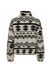 Pull en polaire avec col haut, de couleur crème, orné de motifs géométriques noirs. Tissu texturé avec un design court et des poignets élastiques.