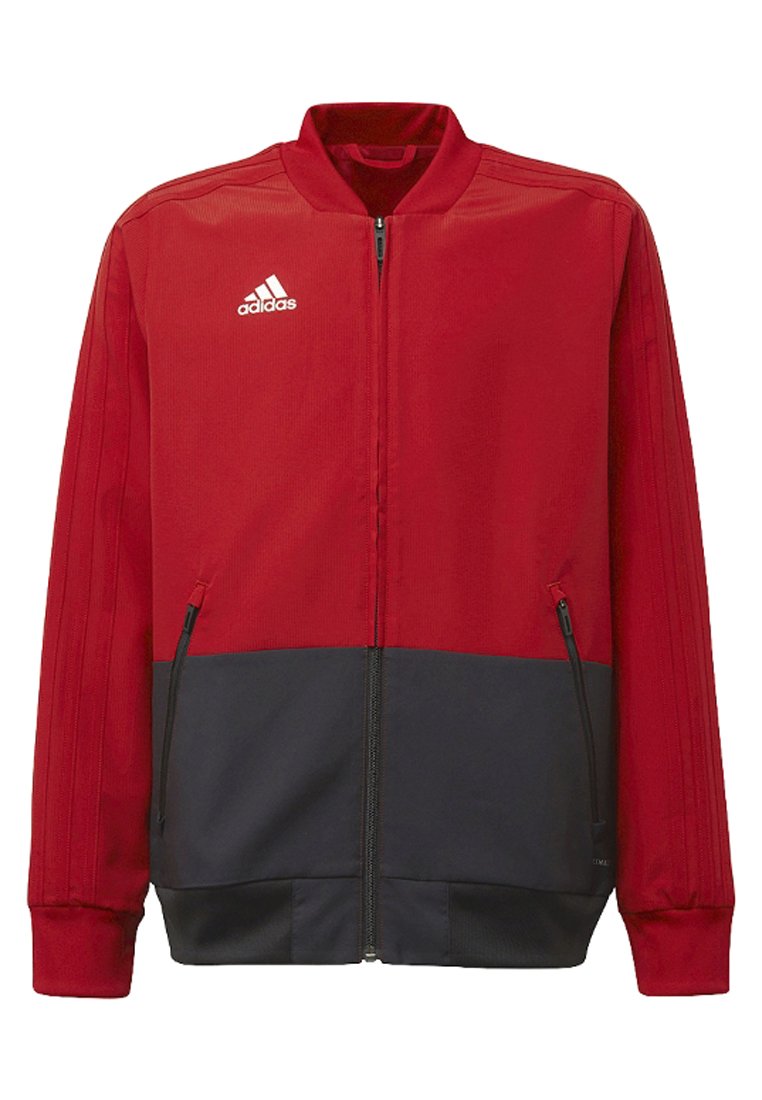 Red and navy zip-up jacket made of smooth fabric. Features a stand collar, side zip pockets, and three-stripe detail on sleeves.