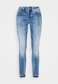 Svetle modré skinny džíny vyrobené z denimu s vybledlým umyvatelným efektem, pět kapes, zipový klíč a knoflíkové zapínání v pase.