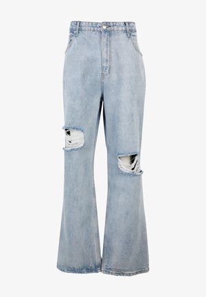 Lyseblå cowboybukser med høj talje, vide ben og markante slidte huller på begge knæ samt flossede kanter omkring hullerne.