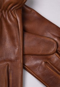 Brown leather gloves with a smooth texture and contrasting seams. Features include finger openings and a gathered wrist for fit.