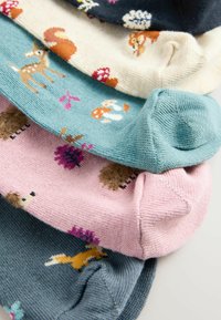 Five pairs of knitted socks in various colors: mint green, pink, cream, navy, and teal, featuring animal and floral patterns throughout.
