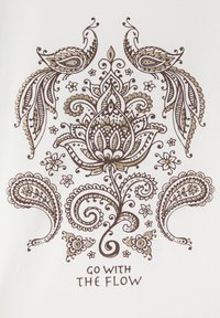 Il tessuto bianco presenta intricate decorazioni paisley e floreali in marrone e oro, con due pavoni in cima e la frase "SEGUI IL FLUSSO" sotto.