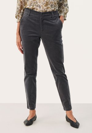 Donkergrijze corduroy broek met een slim fit ontwerp, voorzien van zijzakken en een soepele textuur. Gemaakt met een patroon blouse en zwarte platte schoenen.