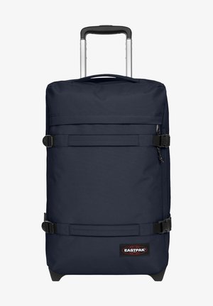 Granatowa torba podróżna na kółkach z wieloma paskami, materiałową rączką i logo Eastpak. Gładki materiał, prostokątny kształt i solidne kółka.