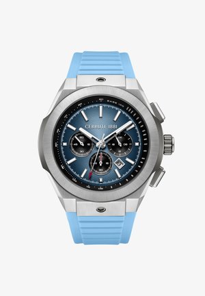 Srebrny zegarek chronograf z niebieską tarczą, trzema subtarczami, okienkiem daty na godzinie 4 oraz jasnoniebieskim silikonowym paskiem.