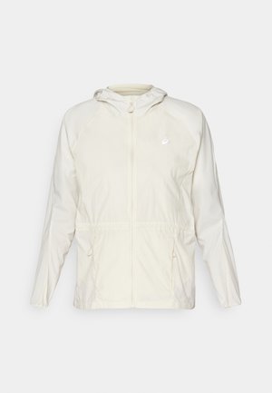 Viegls, krēmkrāsas žakets ar priekšējo rāvējslēdzēju, regulējamu auklu jostasvietā un garām piedurknēm ar kapuci.