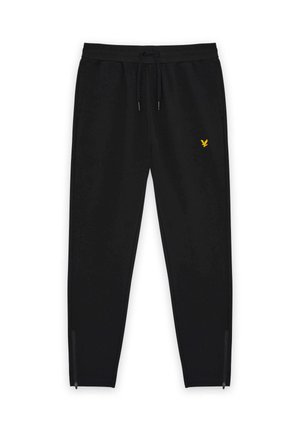 Black tapered jogger pants with drawstring waist, yellow embroidered logo on thigh, and zippers at ankle cuffs.