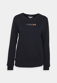 Felpa nera con maniche lunghe, polsini e orlo a coste. Presenta un ricamo colorato "HILFIGER" sulla parte anteriore. Tessuto morbido al tatto.
