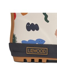Gumena cipela s kremastim gornjim dijelom, ukrašena šarenim apstraktnim uzorcima. Crni teksturirani potplat s utorima i Liewood logom.