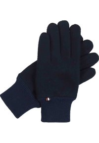 Gants en tricot bleu marine avec des poignets côtelés. Texture douce, design standard à cinq doigts, et une petite étiquette d'accent près du poignet.
