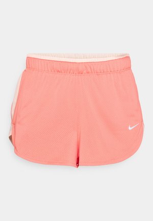 Pink athletic shorts made of mesh fabric with an elastic waistband, featuring a white logo and side slits for enhanced movement.