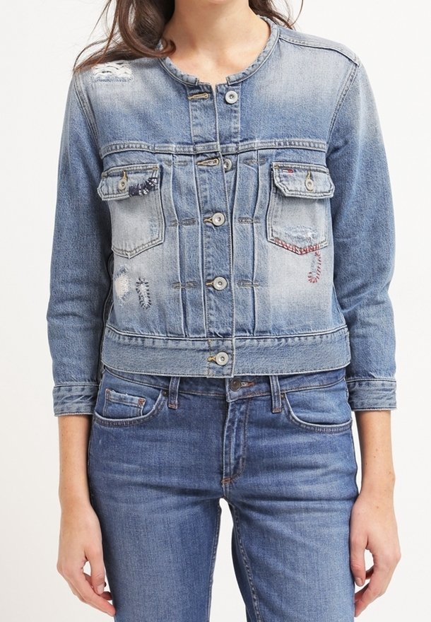 Jeansjacka i ljusblått, med en kortad design, knappstängning, två bröstfickor och slitna detaljer.