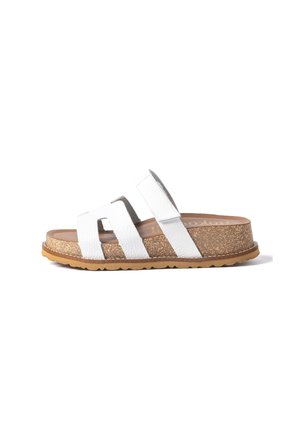 White open-toe sandal with two wide leather straps, cork footbed, and textured rubber sole, shown in side profile on white background.