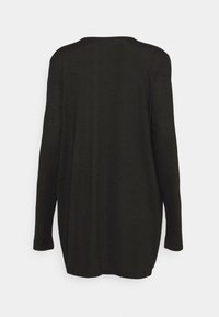 Haut noir à manches longues avec un ourlet légèrement arrondi, une texture douce, un col rond et un design minimaliste. Vue de dos montrant des lignes épurées.