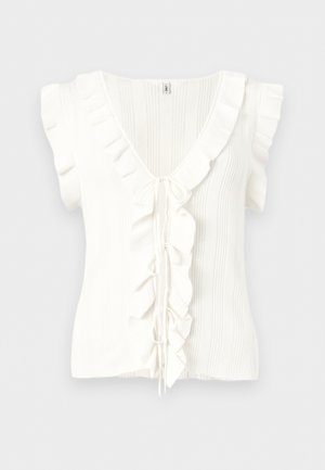 Haut en maille blanc sans manches à rayures verticales, col en V, bordure volantée le long de l'encolure et à l'avant, avec des liens de fermeture au centre.