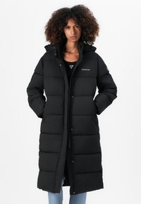 Black puffer coat with a long design, quilted texture, and a zippered front. Features a hood and logo detail on the chest.