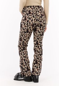 Panty met luipaardprint in tinten van room, bruin en zwart. Gemaakt van een soepel materiaal, met een slim fit en een elastische tailleband.