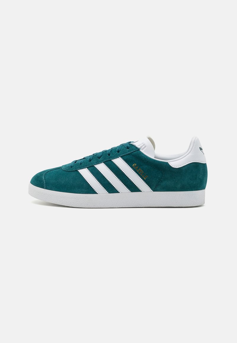 Teal suede sneaker with white leather accents and three white stripes. Features round toe, laced design, and rubber sole. Gold logo detail.