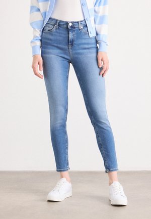 Light blue skinny jeans with a high waist, made of denim. Features a faded finish, five pockets, and neat stitching along the seams.