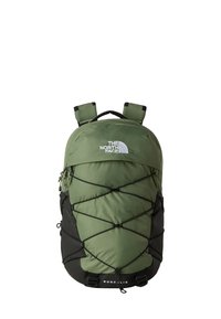 Green nylon backpack with black accents, featuring a bungee cord system on the front, adjustable straps, and a logo at the top.