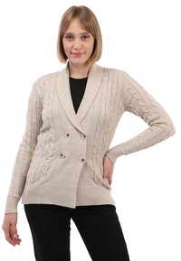 Béžový pletený cardigan s kabelovým vzorem, dvouřadým zapínáním, širokým límcem a dlouhými rukávy. Obsahuje knoflíky a kapsy na přední straně.