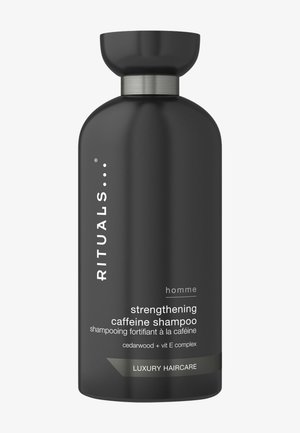 Schwarze Flasche des Rituals homme stärkenden Koffein-Shampoos mit Zedernholz und Vitamin E, luxuriöses Haarpflegeprodukt.