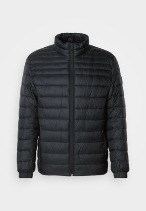 Crna prešana puffer jakna s visokim ovratnikom, punim zatvaračem sprijeda i elastičnim manžetama na dugim rukavima na jednobojnoj pozadini.