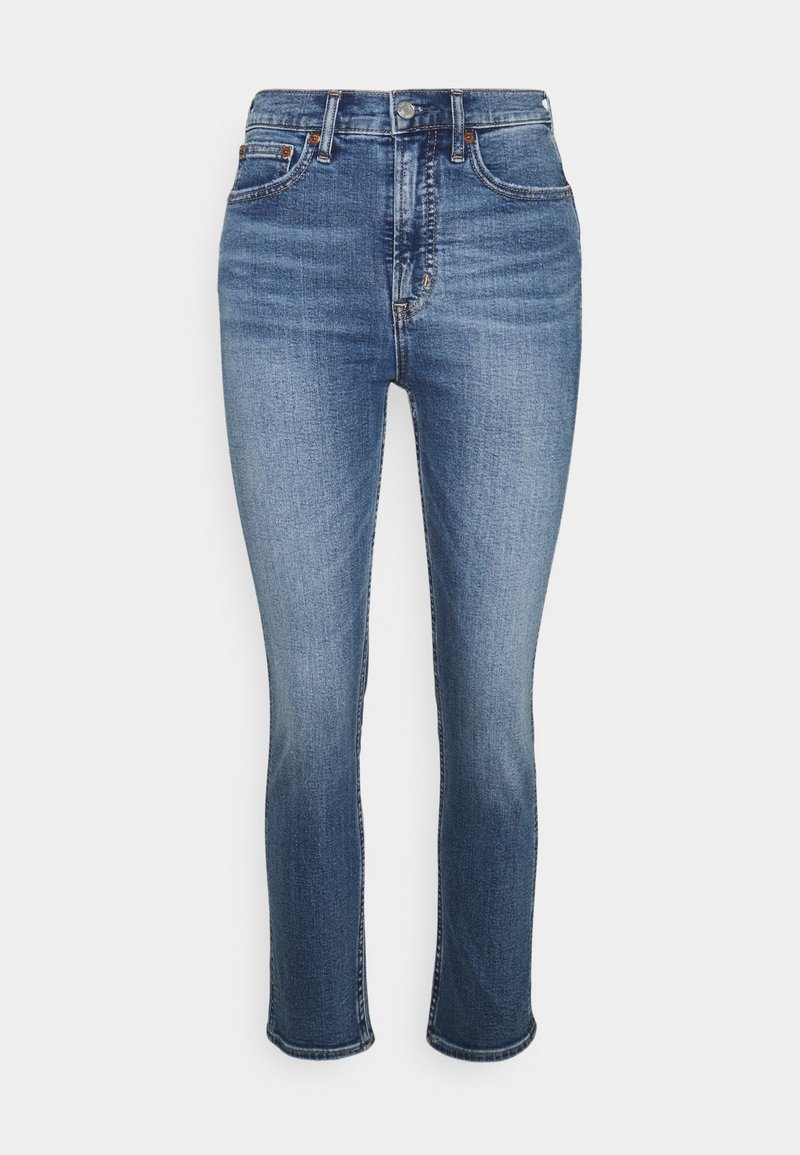 Tmavě modré džíny z denimu s slim fit střihem, středním pasem, designem se pěti kapsami a jemně vybledlým vzorem poblíž stehen a kolen.