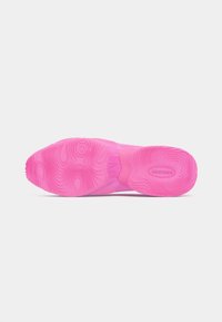 Bright pink sneaker sole with textured, wavy tread pattern and "AIR MAX" branding on the heel area.