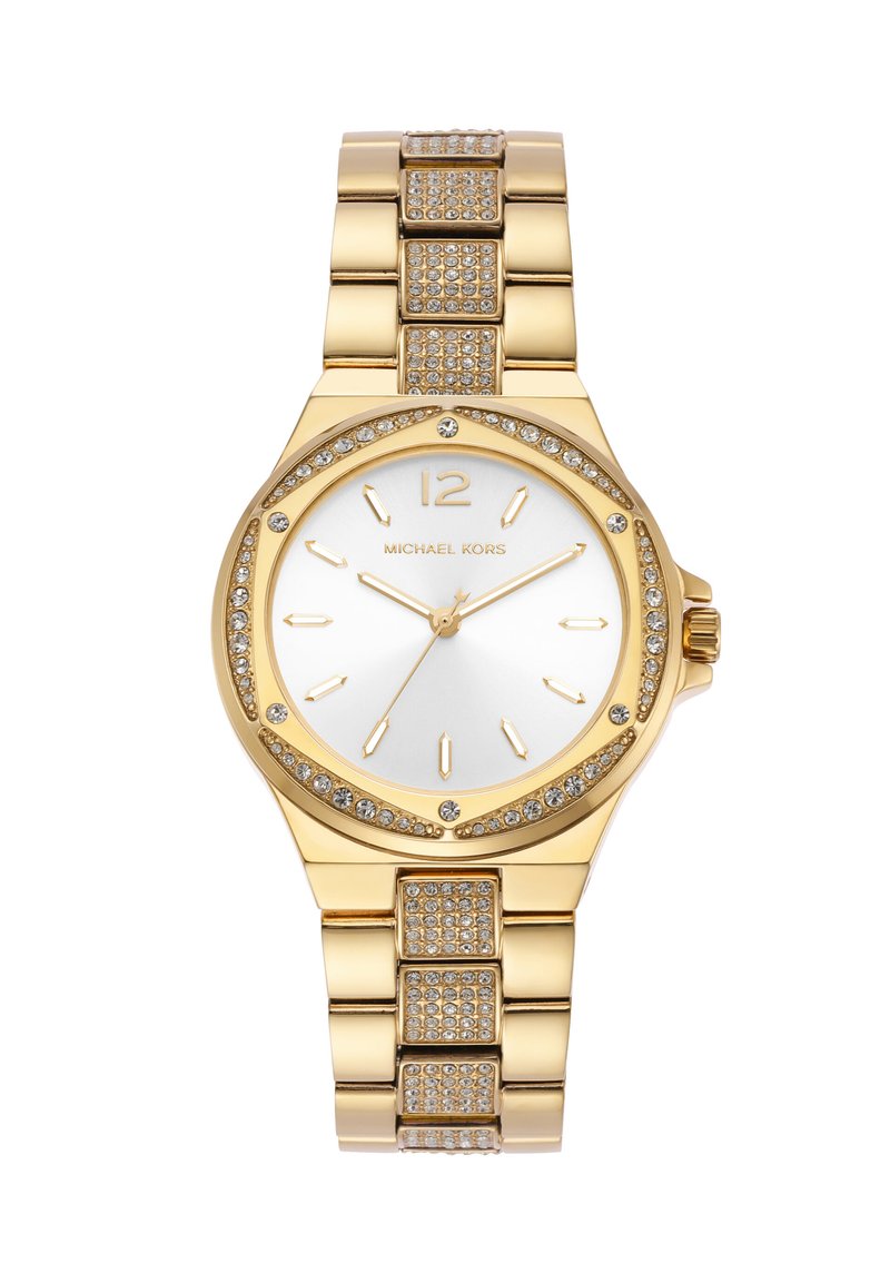 Zelta tonis pulksteņi ar apaļu seju, baltu ciparnīcu, zelta atzīmēm un gredzenu, kas ietverts ar kristāliem. Savienojuma rokassprādze ar teksturētiem akcentiem.