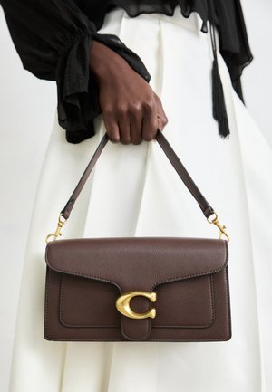 Brown leather handbag with a smooth texture, a gold clasp detail, and a short shoulder strap. The bag features a structured rectangular shape.