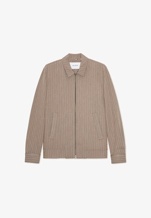 Bēšas krāsas jaciņa ar rāvējslēdzēju, vertikālas baltas svītras, apkakle un sānu kabatas. Izgatavota no teksturēta auduma ar gludu apdari.