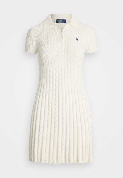 White cable-knit polo dress with short sleeves, featuring a ribbed texture and a two-button placket. Small blue logo on the left chest.