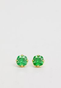 Okrogle zelene kamenčiće naušnice postavljene u zlatu, s postavom na češljeve. Kamenčići imaju fasetiranu površinu koja odražava svjetlost, bez dodatnih ukrasa.