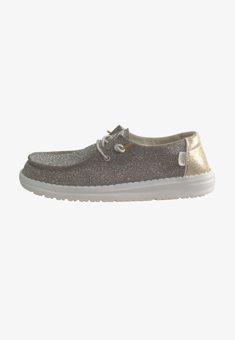 Glittery gray and gold casual shoe with a rounded toe, white sole, metallic accents, and two eyelets for laces. Smooth interior lining.